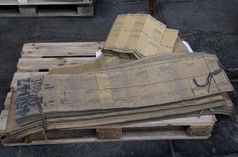 The punched cards of a Jacquard loom: once set, the pattern runs itself