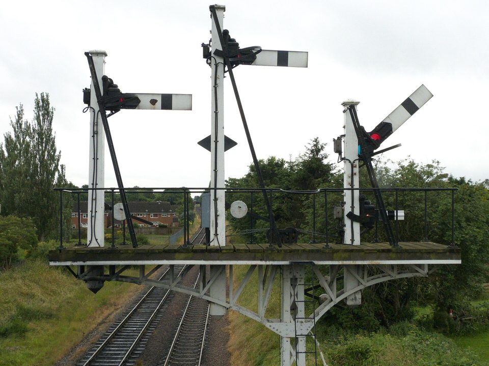 A railway semaphore: one arm, read the same way by everyone in sight